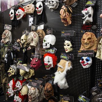 a wall of halloween masks at spirit halloween