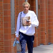 EXCLUSIVE: Pete Davidson wears a sweater with fiancee Ariana Grande's picture in front while out in New York City