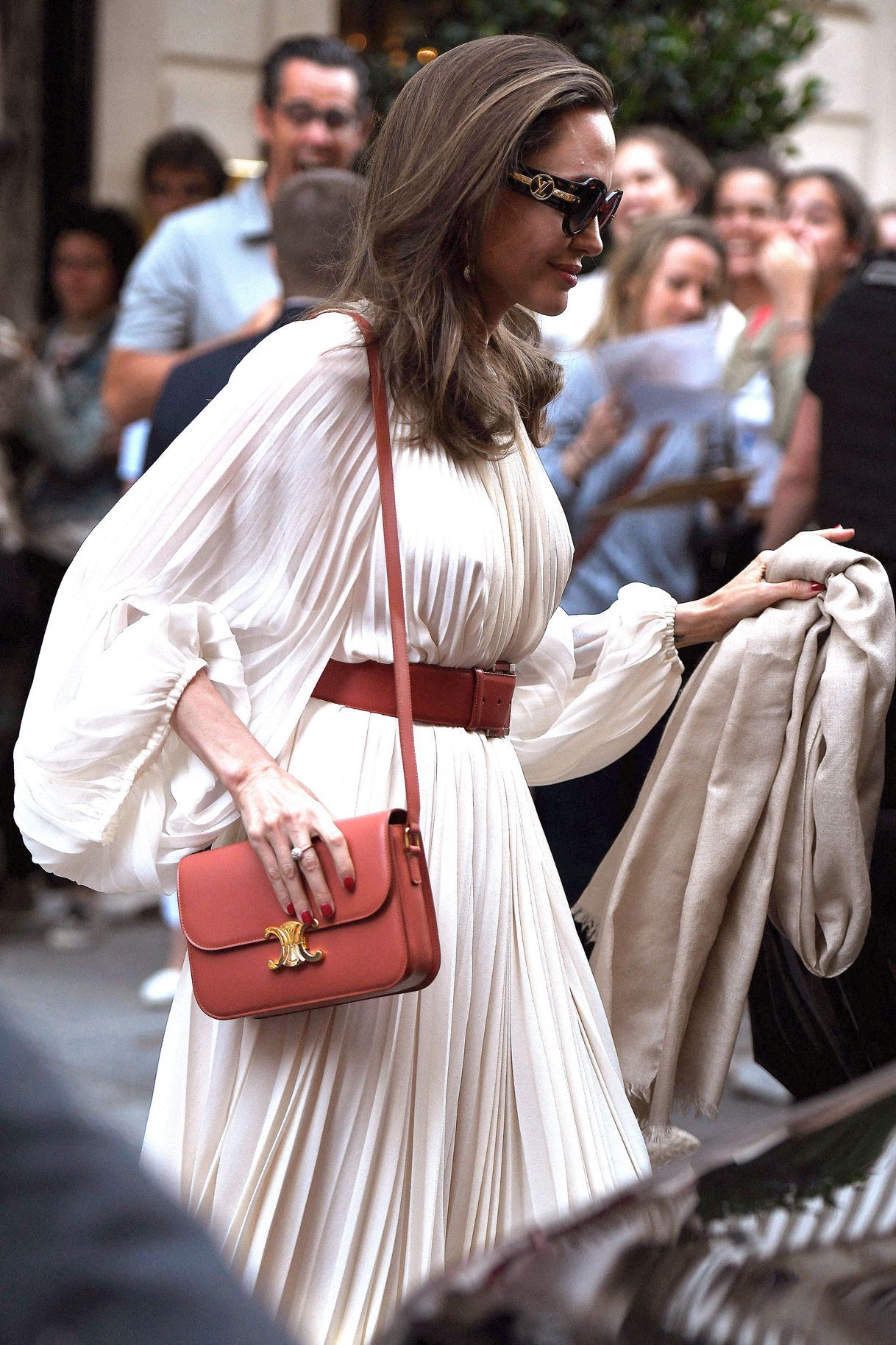 Angelina Jolie in a beige chiffon dress with a letaher belt
