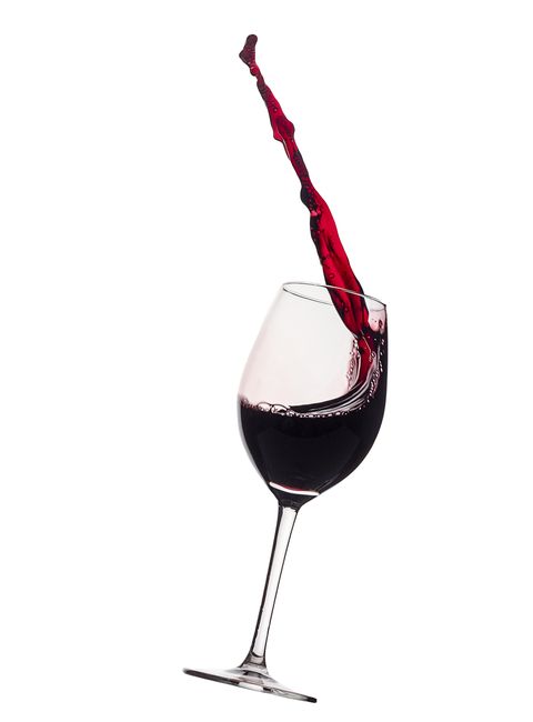 how to look younger splashes and drops from a glass of red wine falling to the ground on a white background
