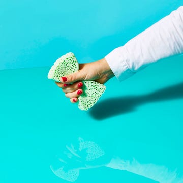 hand holding sponge, washing dishes