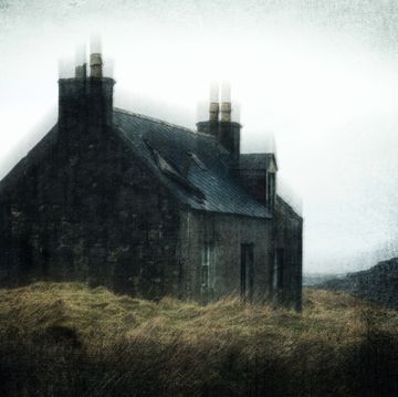 a spooky abandoned ruined cottage on a bleak empty moorland mountain in scotland on a winters day with a grunge, textured edit