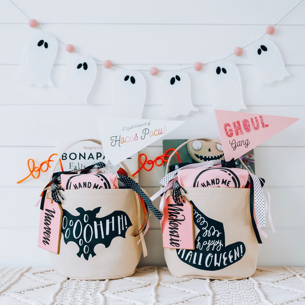 a spooky basket with a bat and witch hat theme
