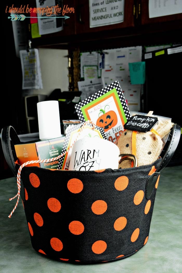 a spooky basket with a warm and cozy theme, featuring a mug and pumpkin biscotti