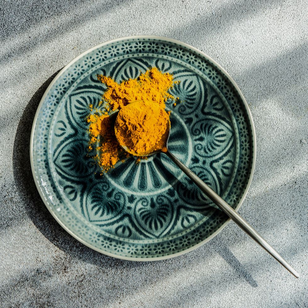 spoonful of turmeric powder on a plate