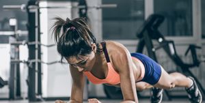 Sport. Muscular woman on a plank position.