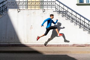 Sportive man exercising on pavement