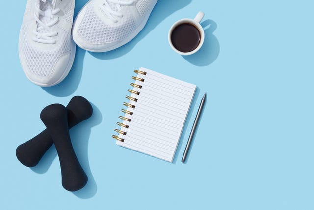 Sports equipment and accessories, shoes, dumbbells, notebook and coffee on blue background