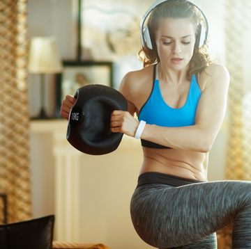 sports woman in headphones doing functional training workout