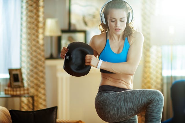 sports woman in headphones doing functional training workout