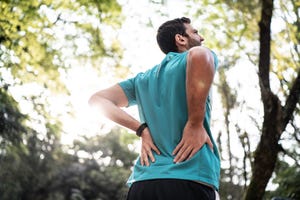 sportsman feeling backache at a park