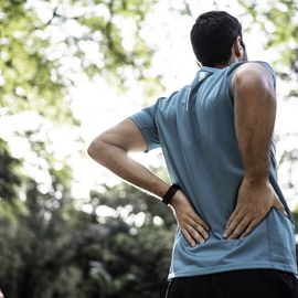 sportsman feeling backache at a park