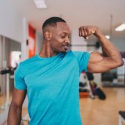 sportsman flexing biceps after workout