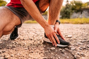 sportsman hurting his ankle during running