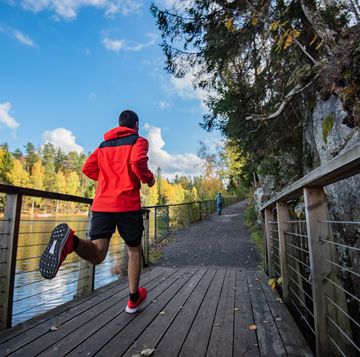 sportsman running on bridge in nature.
