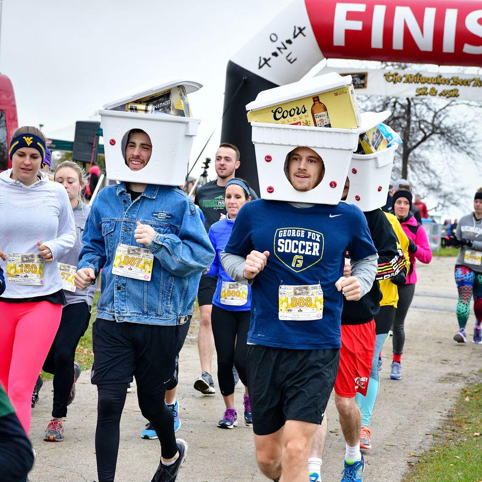 runners in the milwaukee beer run wear coolers on their head