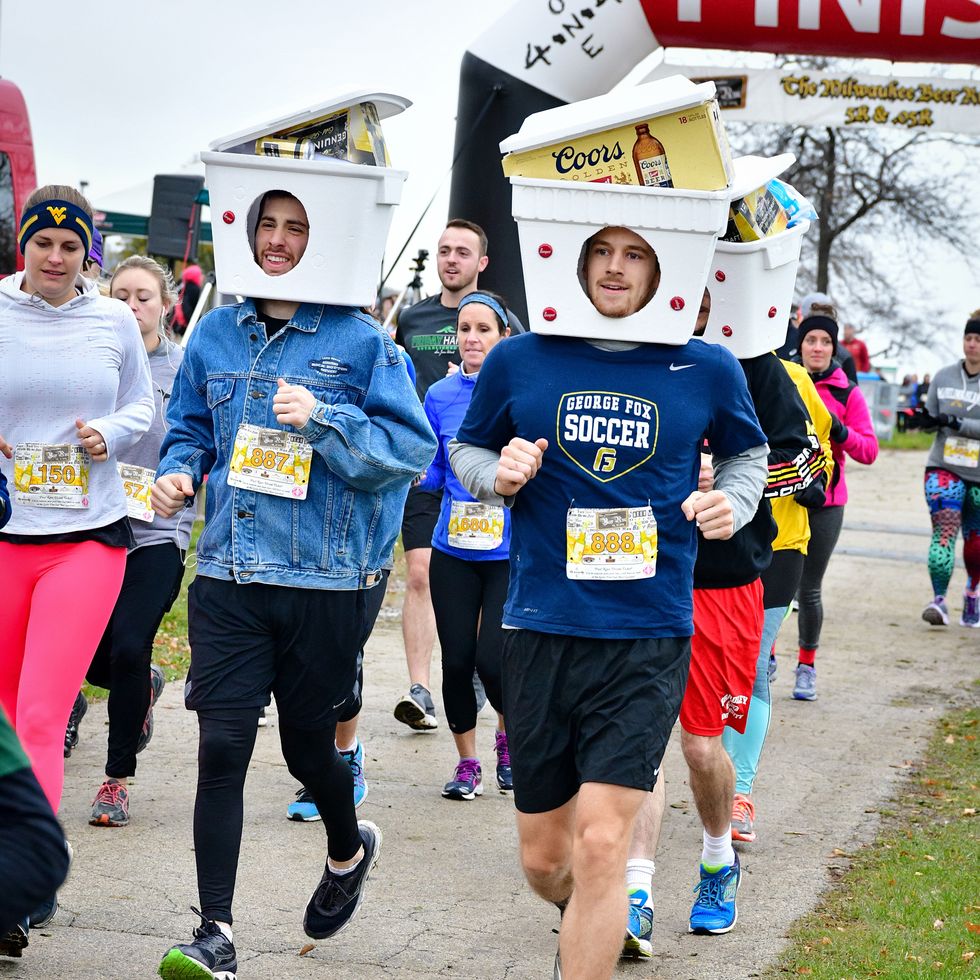 runners in the milwaukee beer run wear coolers on their head