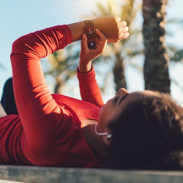 Sportswoman checking pulse on smartwatch Sportswoman checking pulse on smartwatch