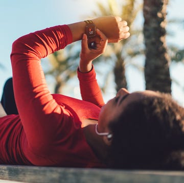 Sportswoman checking pulse on smartwatch