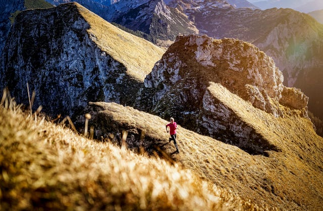sportswoman exercising while running on aggenstein mountain at bavaria, germany