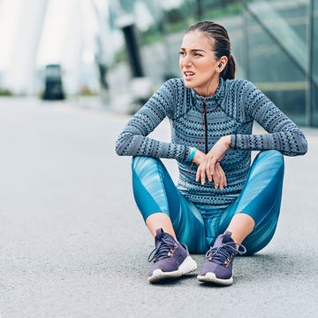 sportswoman sitting on floor and breathing heavily