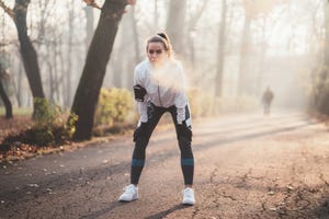 Sportswoman taking a breath after jogging