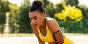 nasal breathing while Kareem running sporty black woman in yellow sportswear resting after run