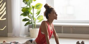 sporty girl do upward facing dog exercise on yoga mat
