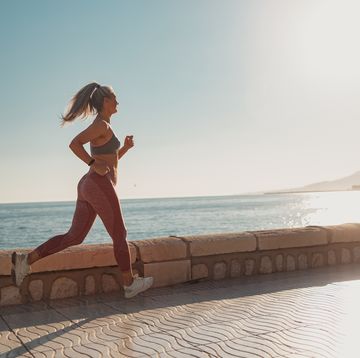 sporty lady actively jogging by the waterfront