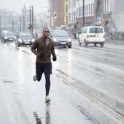 sporty man jogging hiking rainy city scape