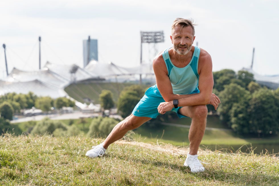 sporty man stretching in a park