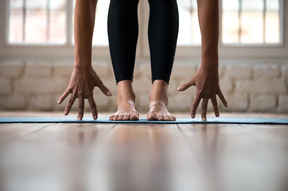 sporty yogi woman practicing yoga, doing bend exercise, standing pose