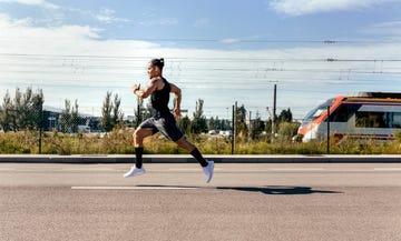 sporty young man running on a road