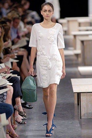 a model wears a dress with rosettes from phillip lim's 2007 collection