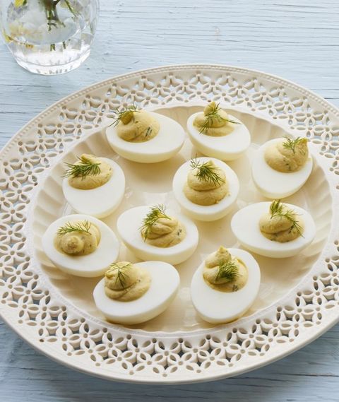 whipped deviled eggs with dill on white plate