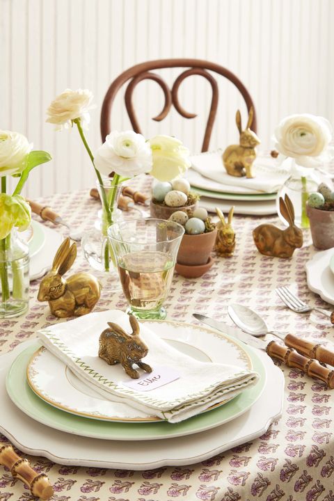 brass bunnies used as a centerpiece on a set table
