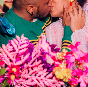 couple kissing surrounded by flowers