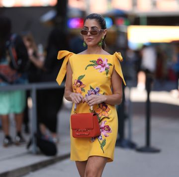new york, new york september 12 a fashion week guest is seen wearing beige sunglasses from carolina herrera, green flower earrings, a sleeveless yellow mini dress with floral embroideries, an orange leather bag from carolina herrera before the carolina herrera spring summer 2024 runway show on september 12, 2023 in new york city photo by jeremy moellergetty images