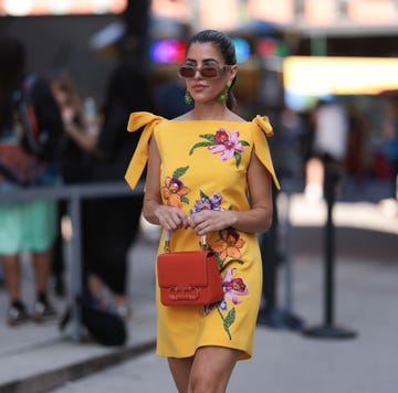 new york, new york september 12 a fashion week guest is seen wearing beige sunglasses from carolina herrera, green flower earrings, a sleeveless yellow mini dress with floral embroideries, an orange leather bag from carolina herrera before the carolina herrera spring summer 2024 runway show on september 12, 2023 in new york city photo by jeremy moellergetty images