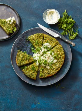 green herb spring frittata on a blue plate