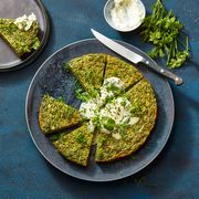 green herb spring frittata on a blue plate