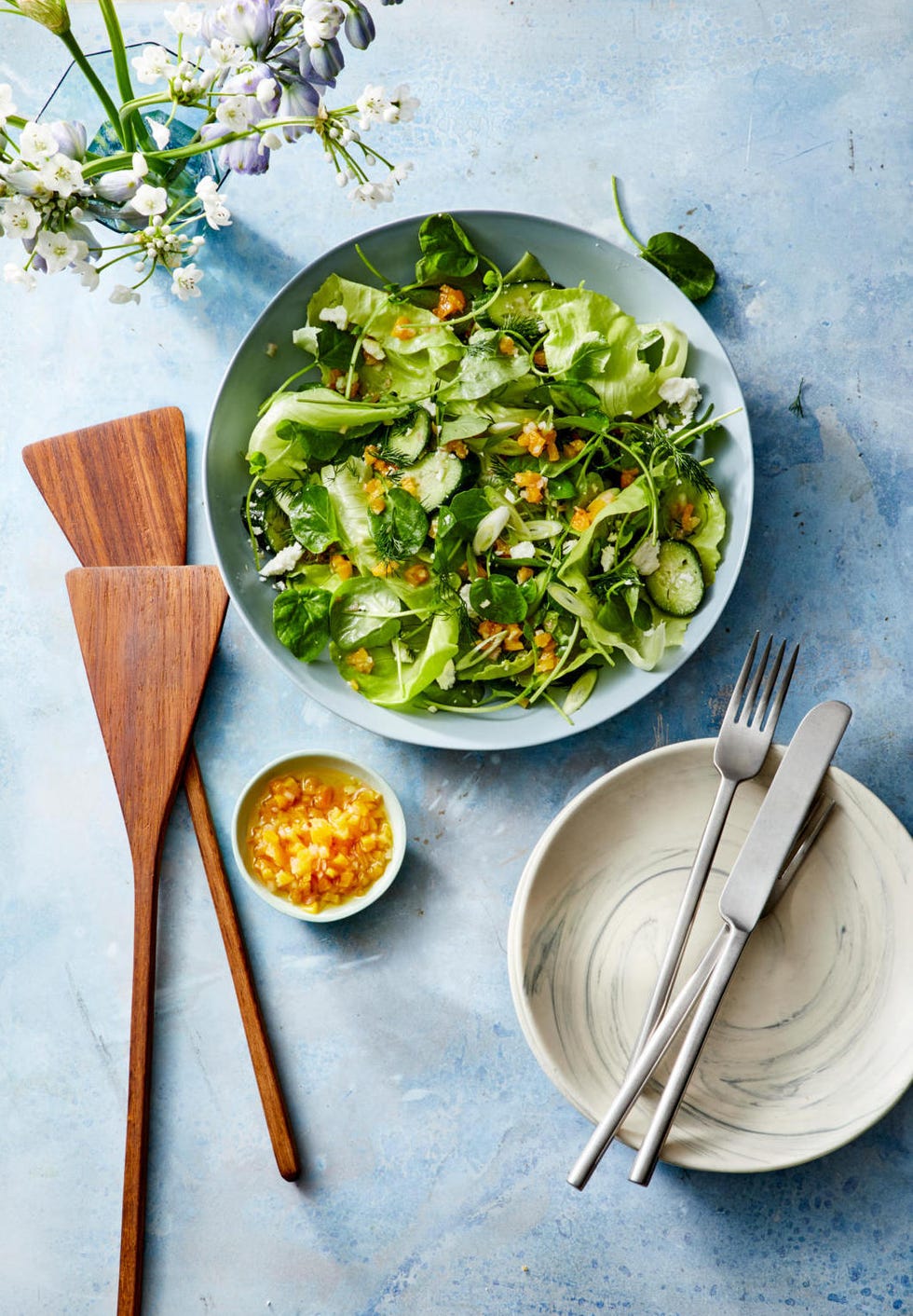 spring salad recipe with apricot vinaigrette on a blue plate
