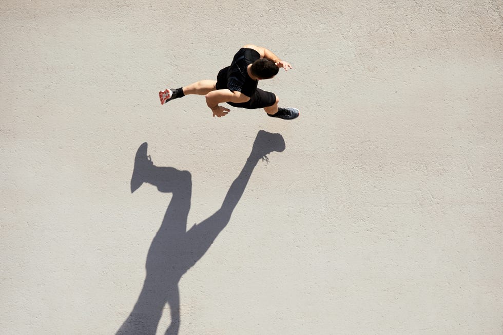 sprinter seen from above with shadow and copy space