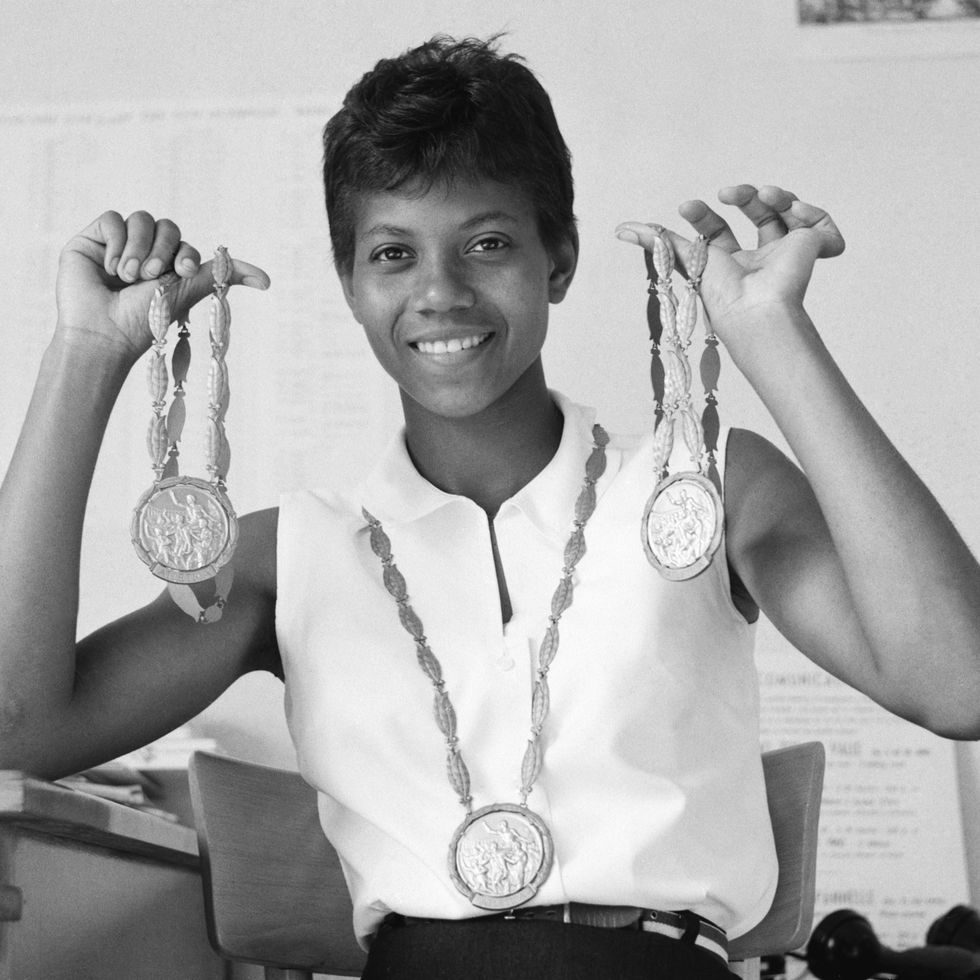 wilma rudolph holding her gold medals