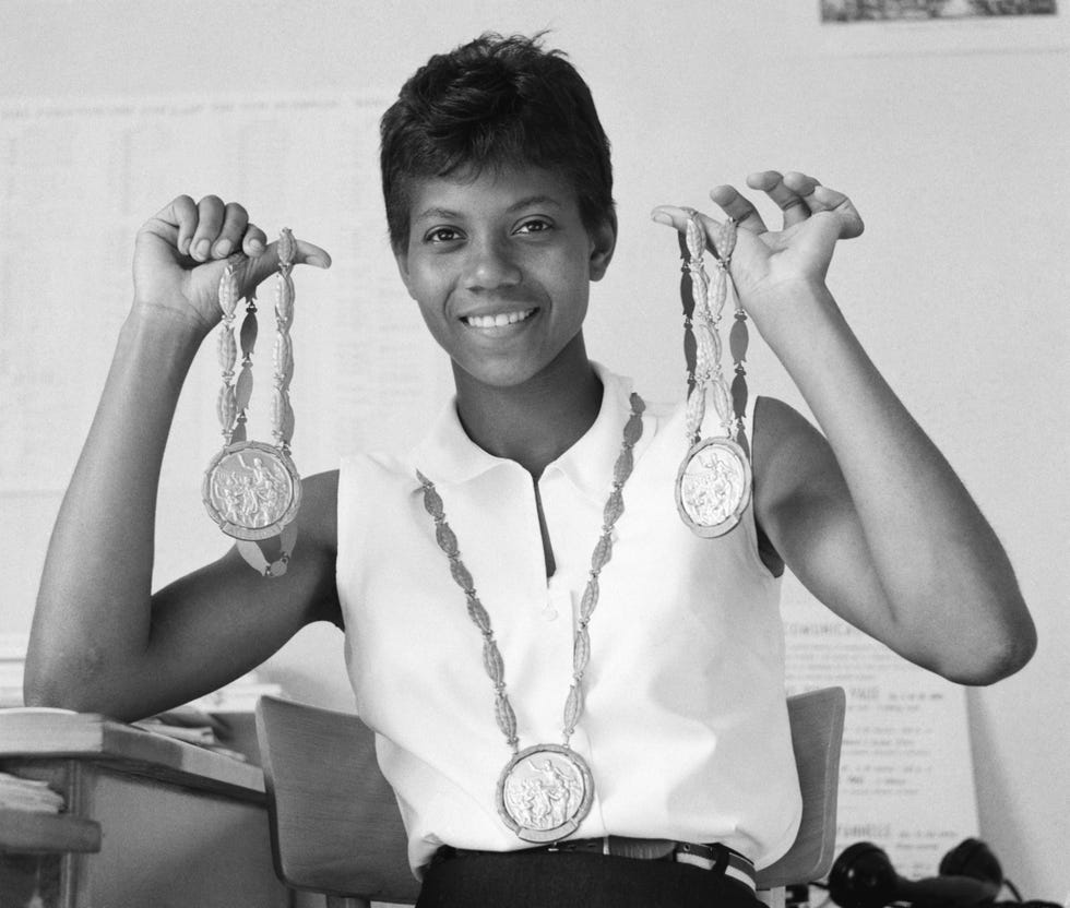 wilma rudolph holding her gold medals