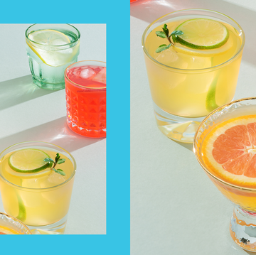 a group of cocktail glasses filled with orange, yellow, and red cocktails