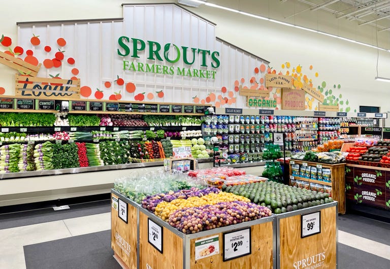 a store with a large display of fruits and vegetables