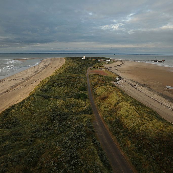 spurn head, england october 12 a general view of spurn point on october 12, 2012 in spurn head, england the spurn point coastal reserve has been managed by the yorkshire wildlife trust since the 1950s after it was purchased from the mod and comprises of a three and a half mile long, narrow and curving peninsula made up of a series of grassy sand and shingle banks, and mudflats the reserve which is only 50 metres wide in places lies on the northern bank of the humber estuary where the north sea meets the humber river and is significantly affected by coastal erosion due to spurns location, it is one of the country’s key areas for ornithological observation, as it is the first land for many migratory species on their way over the north sea to scandinavia and beyond birdwatchers gather during autumn when they are likely to see an array of different migratory birds including bramblings, redstarts, sparrow hawks, shrike, short eared owls storm petrols, gannets, knot and oystercatchers rarer species are also common sightings including raddes warbler, nightingale and firecrest photo by dan kitwoodgetty images