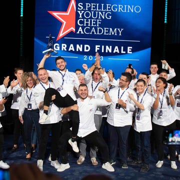 the chef finalists lift up the winner, who is holding a trophy the chef finalists lift up the winner, who is holding a trophy