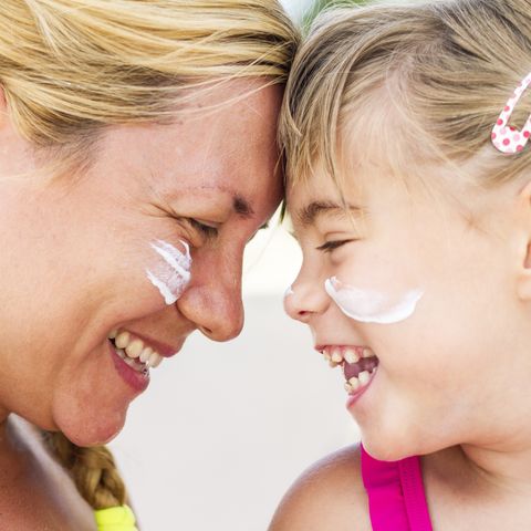 mother and daughter with sunscreen on faces